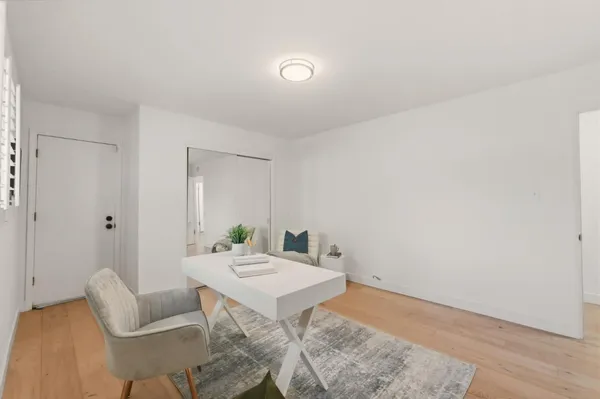 a bathroom with a toilet sink vanity granite and shower