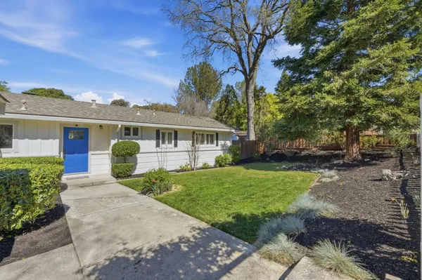 a front view of a house with garden