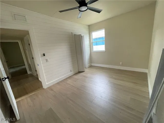 a kitchen with a sink cabinets stainless steel appliances and windows