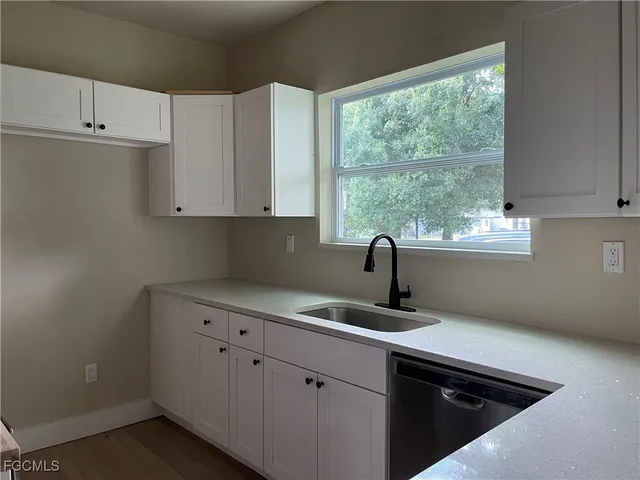 a kitchen with a sink stove and cabinets