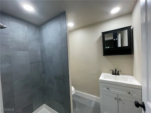 a view of wooden floor and a chandelier fan in a room