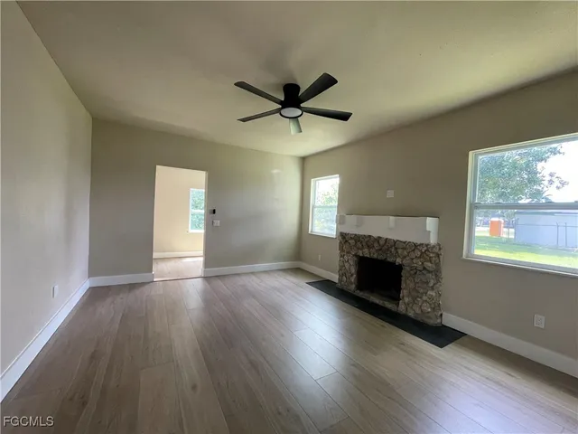 a kitchen with a sink window and cabinets