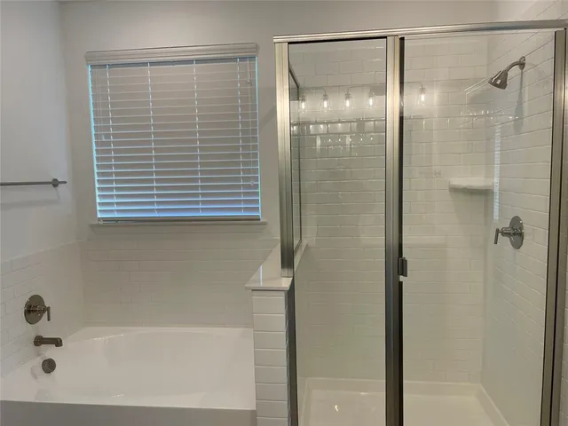 a bathroom with a bathtub and shower