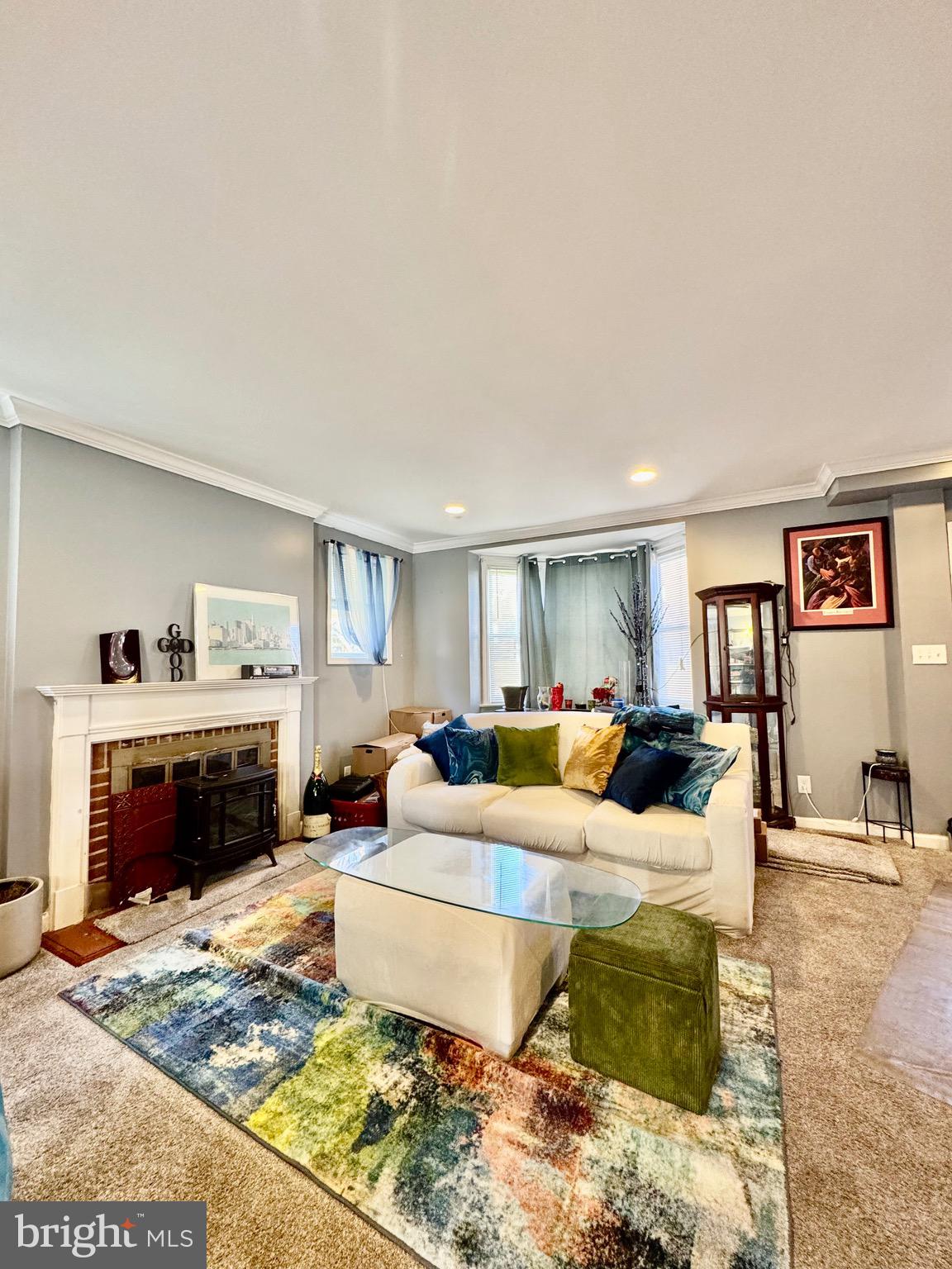 1519 Northgate Road Baltimore, MD 21218 - Photo 13 of 34 a living room with furniture large window and a fireplace