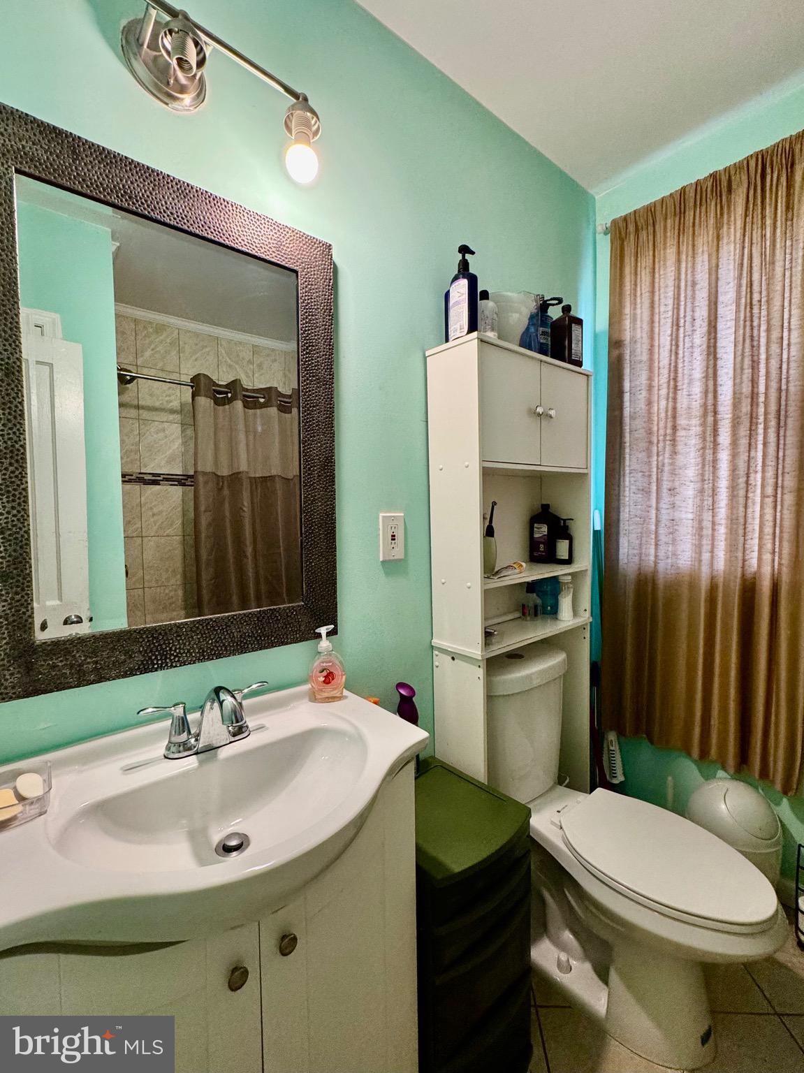 1519 Northgate Road Baltimore, MD 21218 - Photo 17 of 34 a bathroom with a sink toilet and shower