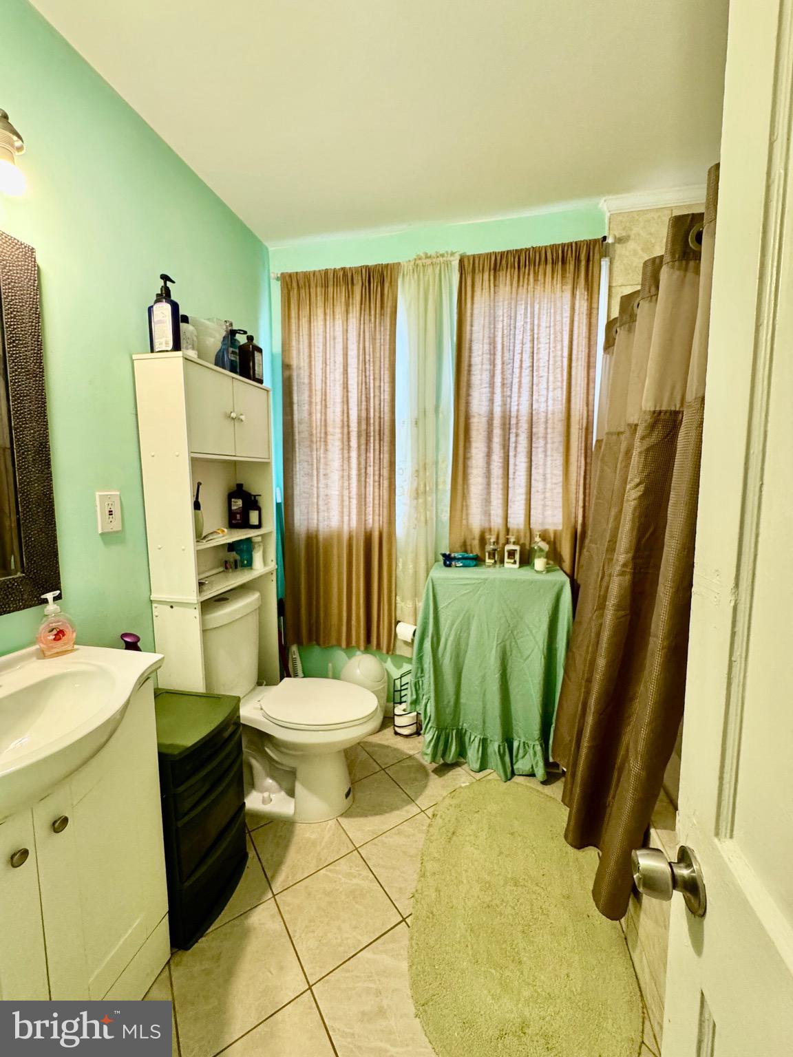 1519 Northgate Road Baltimore, MD 21218 - Photo 18 of 34 a bathroom with a sink toilet and shower