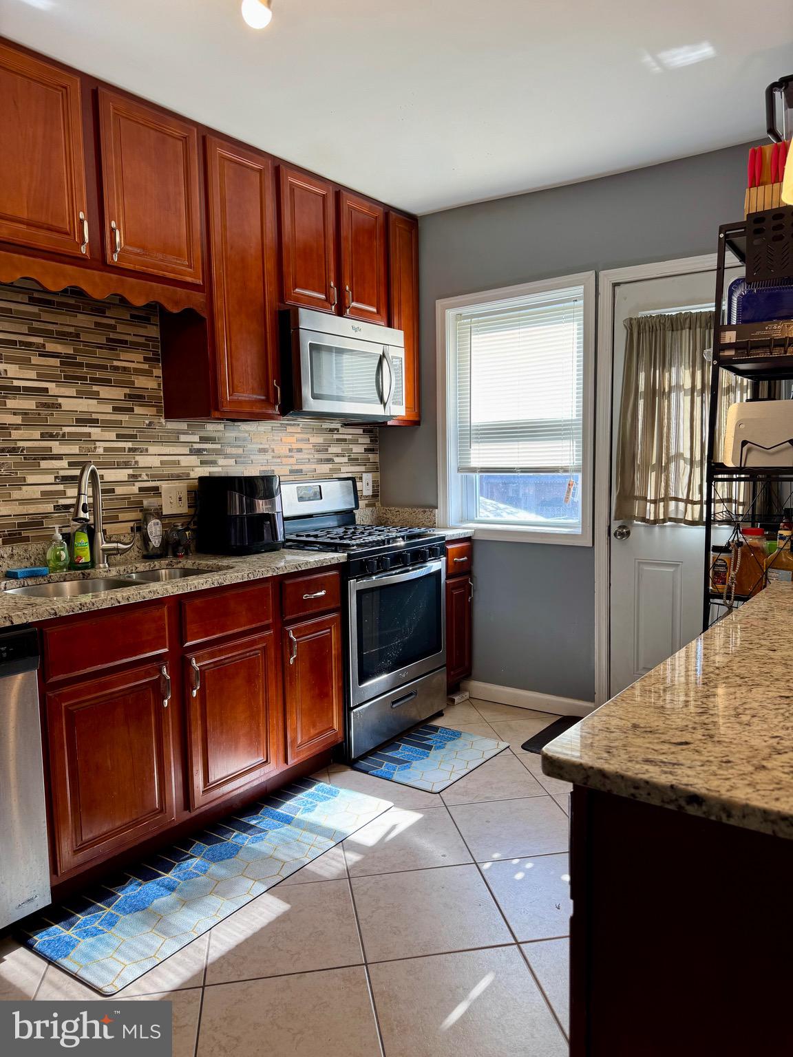1519 Northgate Road Baltimore, MD 21218 - Photo 5 of 34 a kitchen with stainless steel appliances granite countertop a sink stove and refrigerator