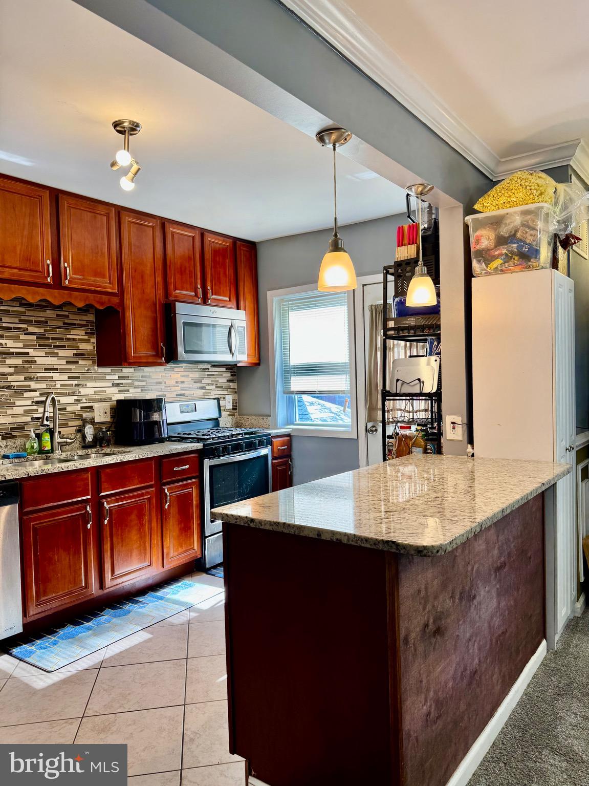 1519 Northgate Road Baltimore, MD 21218 - Photo 6 of 34 a kitchen with stainless steel appliances granite countertop a sink a stove and a refrigerator