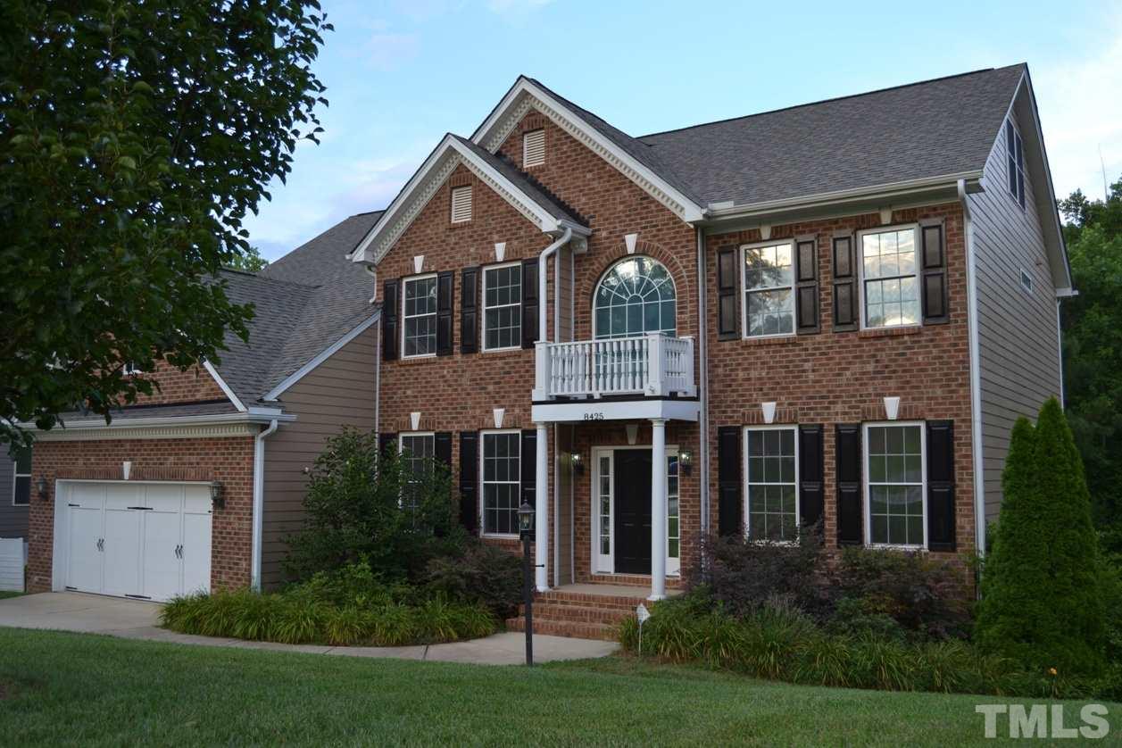 8425 Henderson Road Apex, NC 27539 - Photo 1 of 25 a front view of a house with a yard and trees
