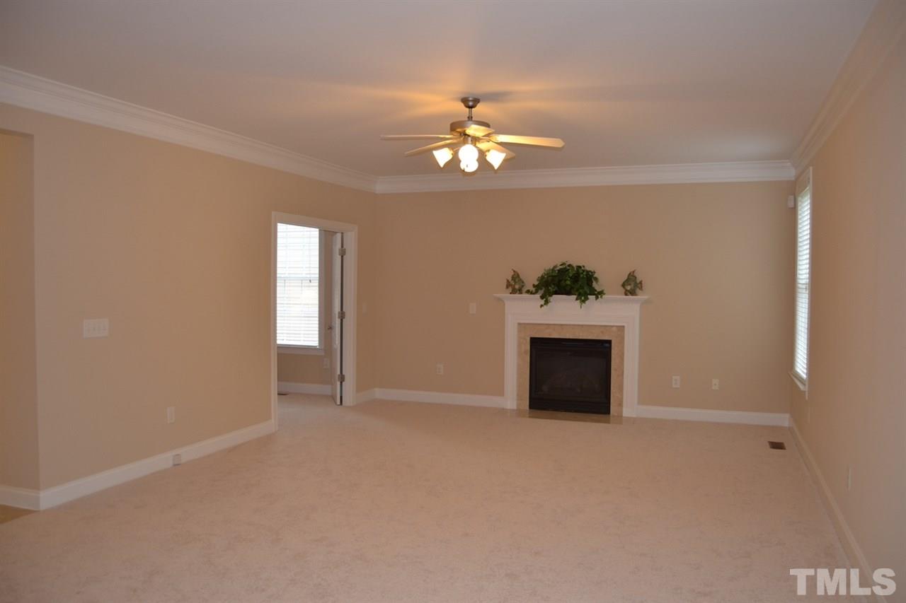 8425 Henderson Road Apex, NC 27539 - Photo 12 of 25 a view of empty room with a fireplace