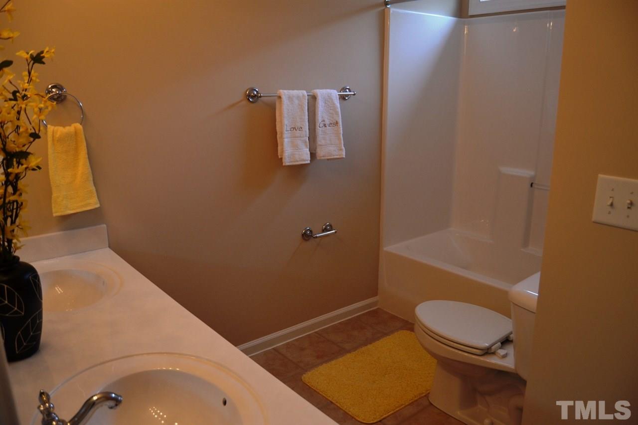 8425 Henderson Road Apex, NC 27539 - Photo 13 of 25 a bathroom with a sink toilet and shower