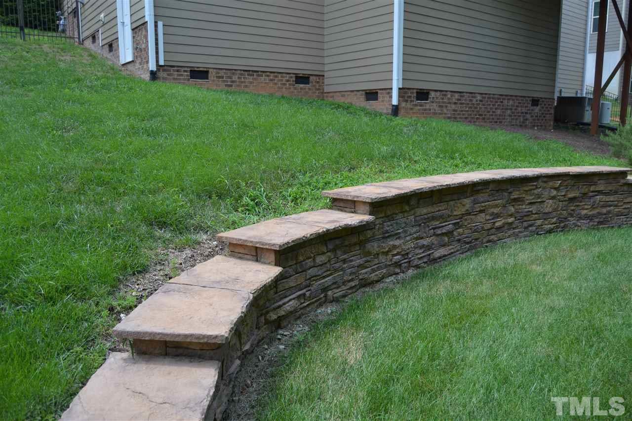 8425 Henderson Road Apex, NC 27539 - Photo 22 of 25 a view of a backyard with wooden fence