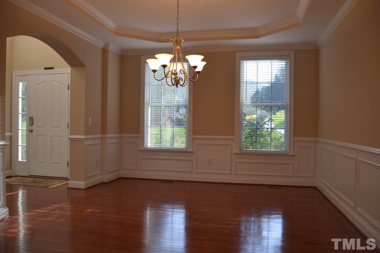 8425 Henderson Road Apex, NC 27539 - Photo 9 of 25 a view of a room with wooden floor chandelier and windows
