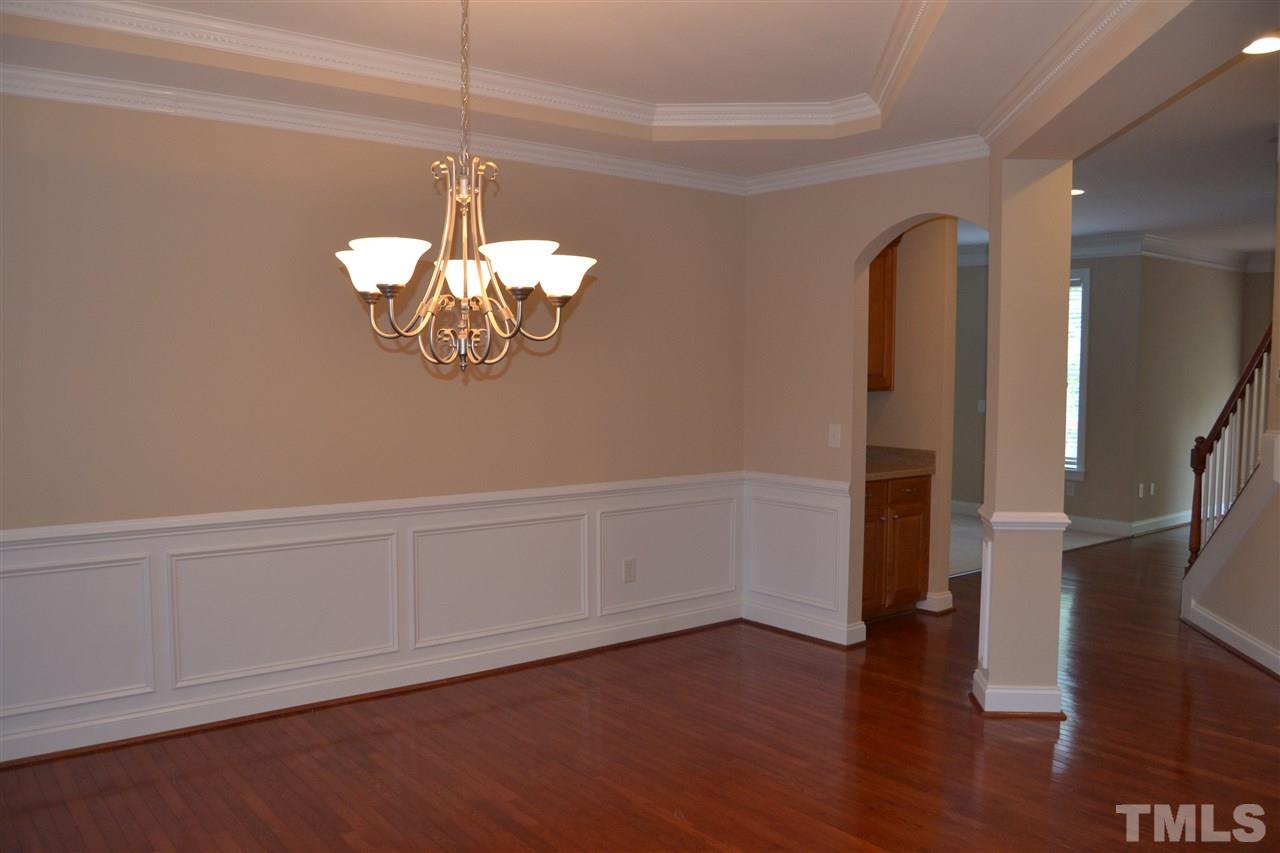 8425 Henderson Road Apex, NC 27539 - Photo 10 of 25 a view of an empty room with wooden floor and a window