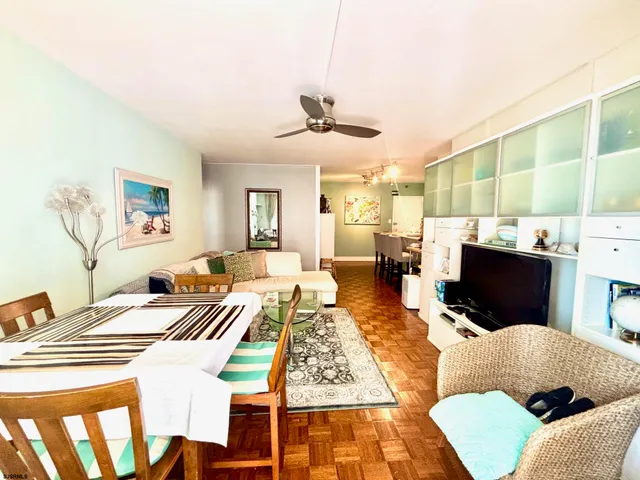a living room with fireplace furniture and a rug