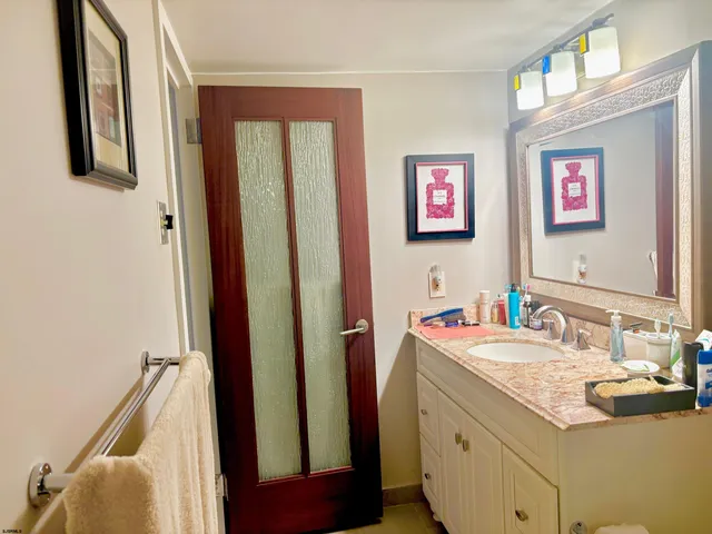 a bathroom with a sink vanity and mirror