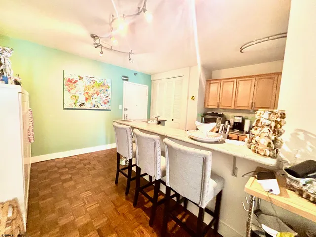 a large white kitchen with a sink and cabinets