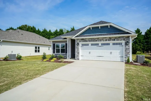 a front view of house with yard outdoor seating and barbeque oven