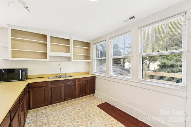 a kitchen with stainless steel appliances granite countertop a sink and cabinets