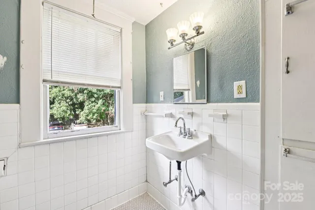 a bathroom with a sink a mirror and a window