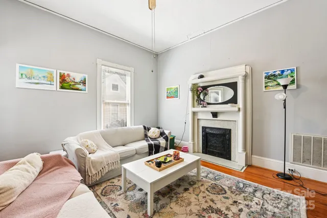 a living room with furniture a rug and a fireplace