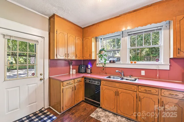 a kitchen that has a sink and a stove