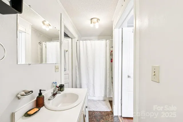 a bathroom with a sink a toilet and mirror