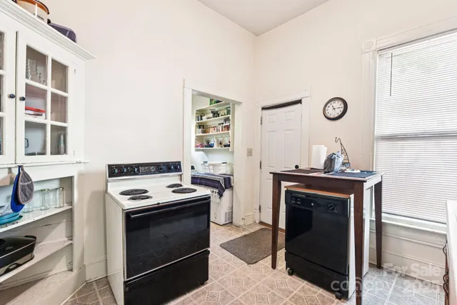 a kitchen with granite countertop a stove and a refrigerator