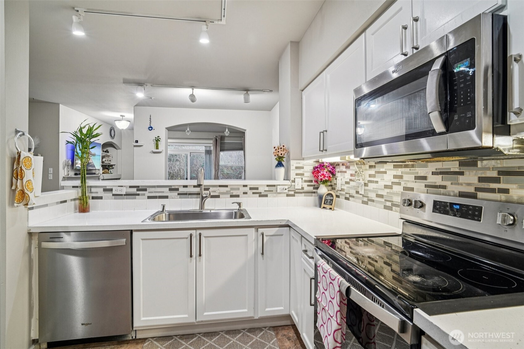 2009 196th Street Southeast, Unit C103 Bothell, WA 98012 - Photo 11 of 30 a kitchen with a sink stove top oven and cabinets