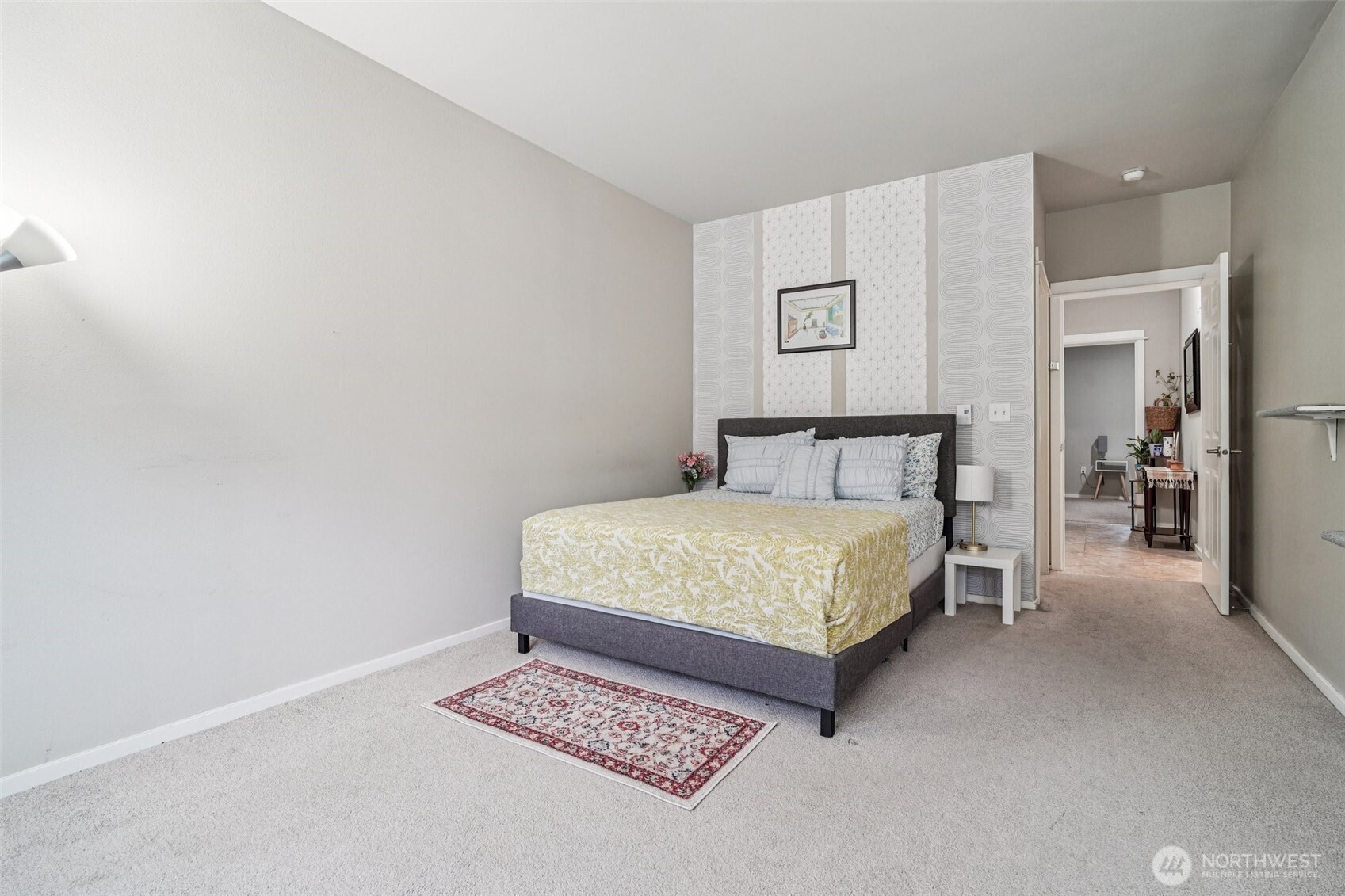 2009 196th Street Southeast, Unit C103 Bothell, WA 98012 - Photo 12 of 30 a bedroom with a bed and painting on the wall