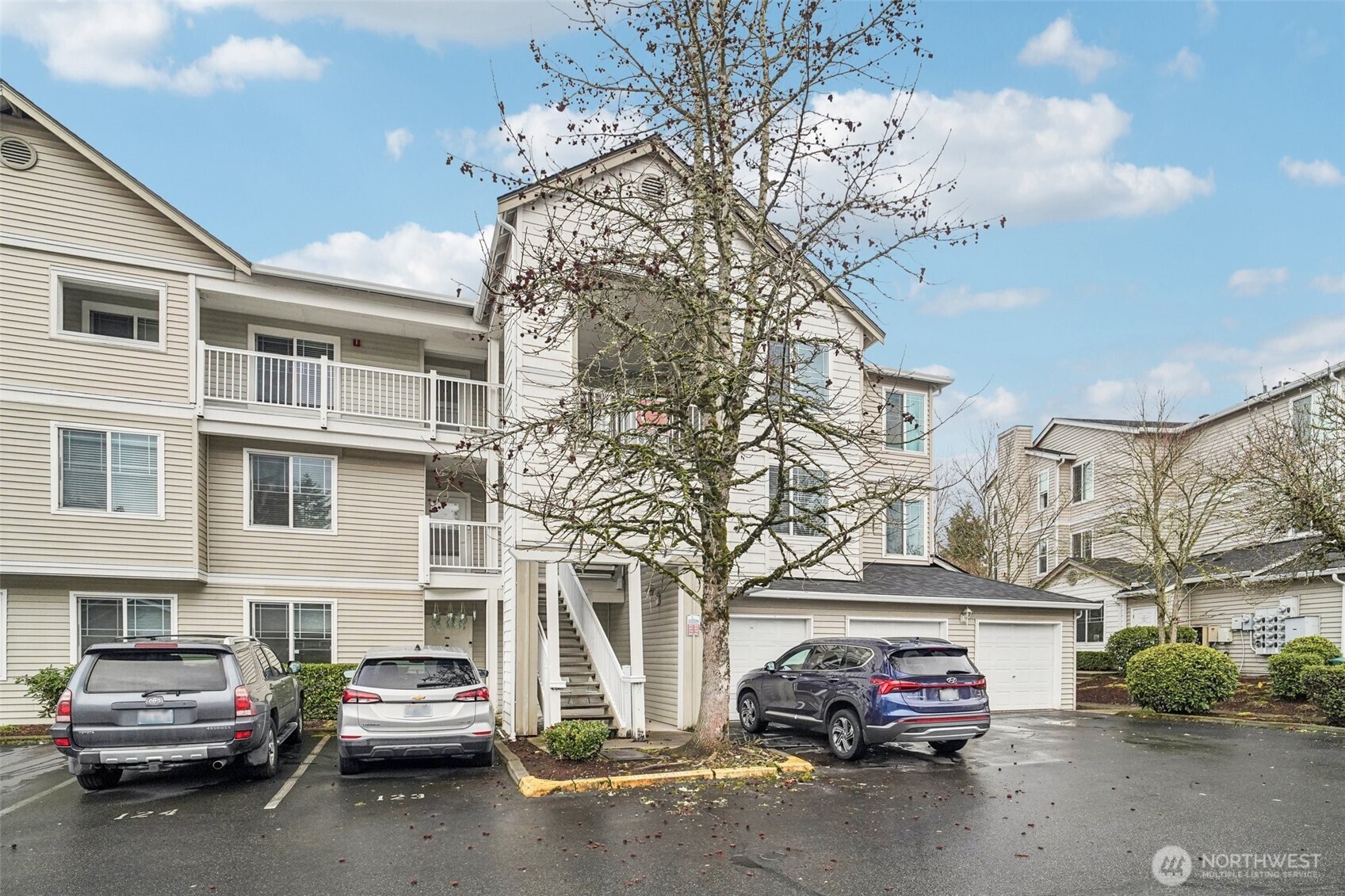 2009 196th Street Southeast, Unit C103 Bothell, WA 98012 - Photo 2 of 30 a car parked in front of a building