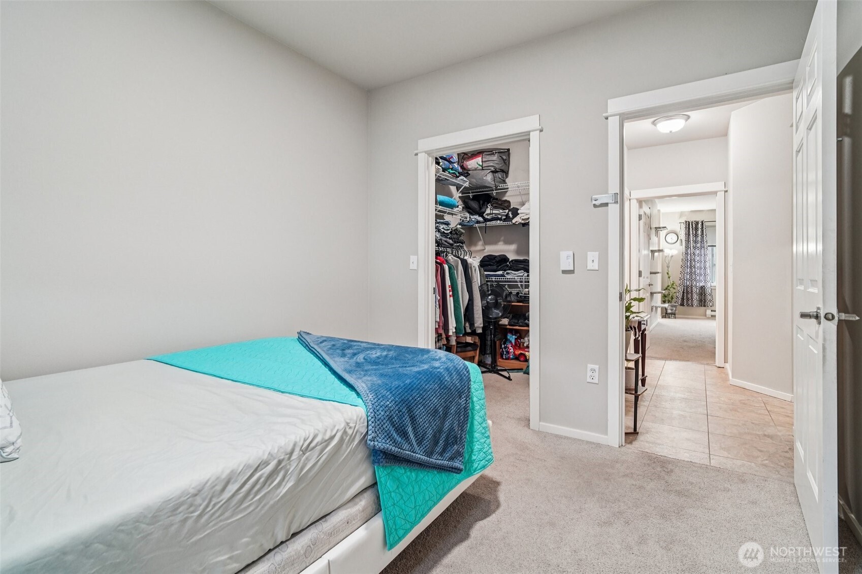 2009 196th Street Southeast, Unit C103 Bothell, WA 98012 - Photo 21 of 30 a bedroom with a bed and a walk in closet