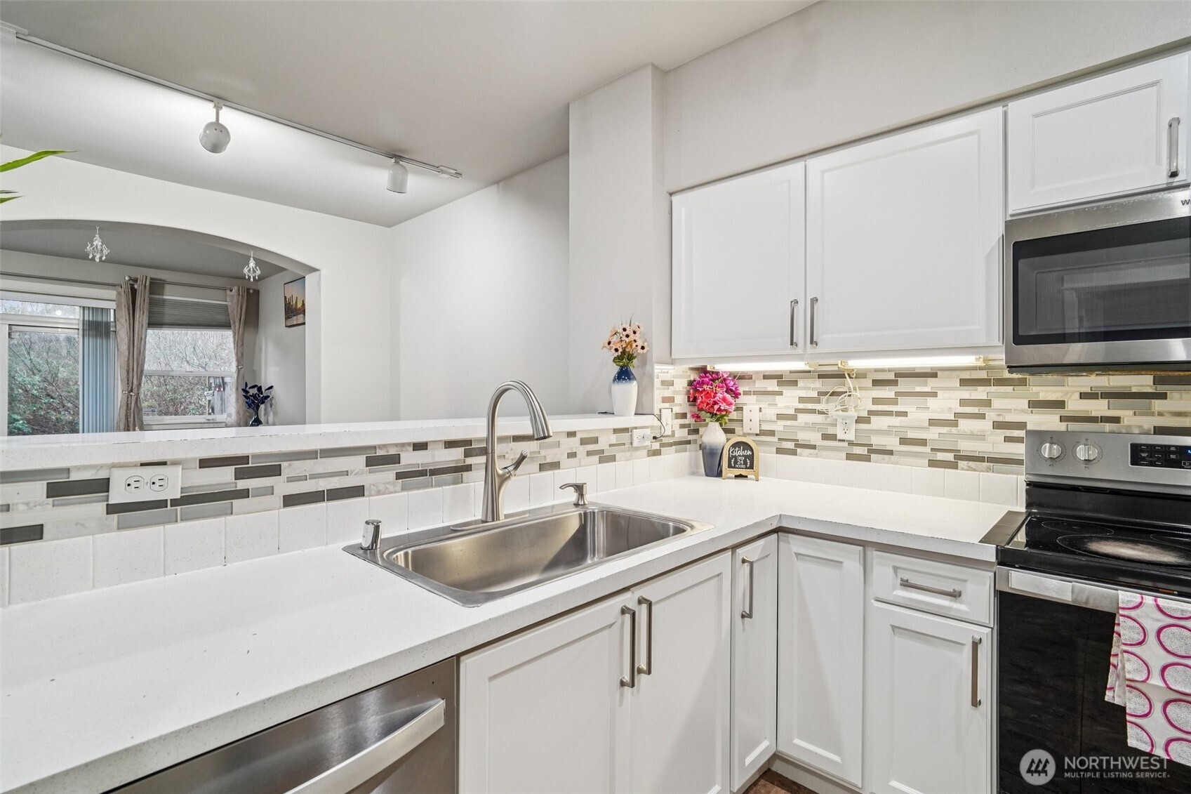 2009 196th Street Southeast, Unit C103 Bothell, WA 98012 - Photo 9 of 30 a kitchen with stainless steel appliances white cabinets sink and stove