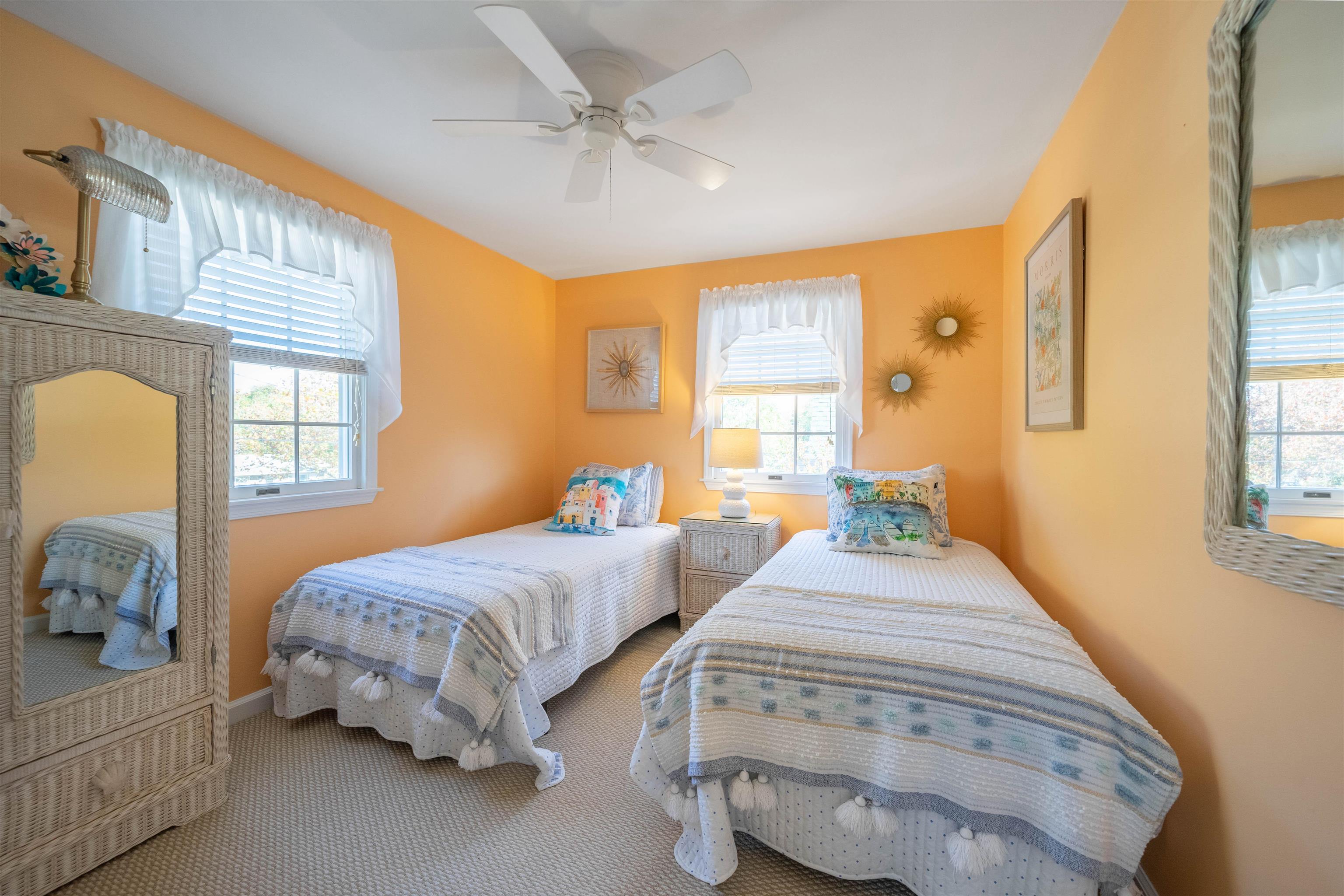 210 3rd West Cape Cape May, NJ 08204 - Photo 20 of 31 a spacious bedroom with two beds and a chandelier