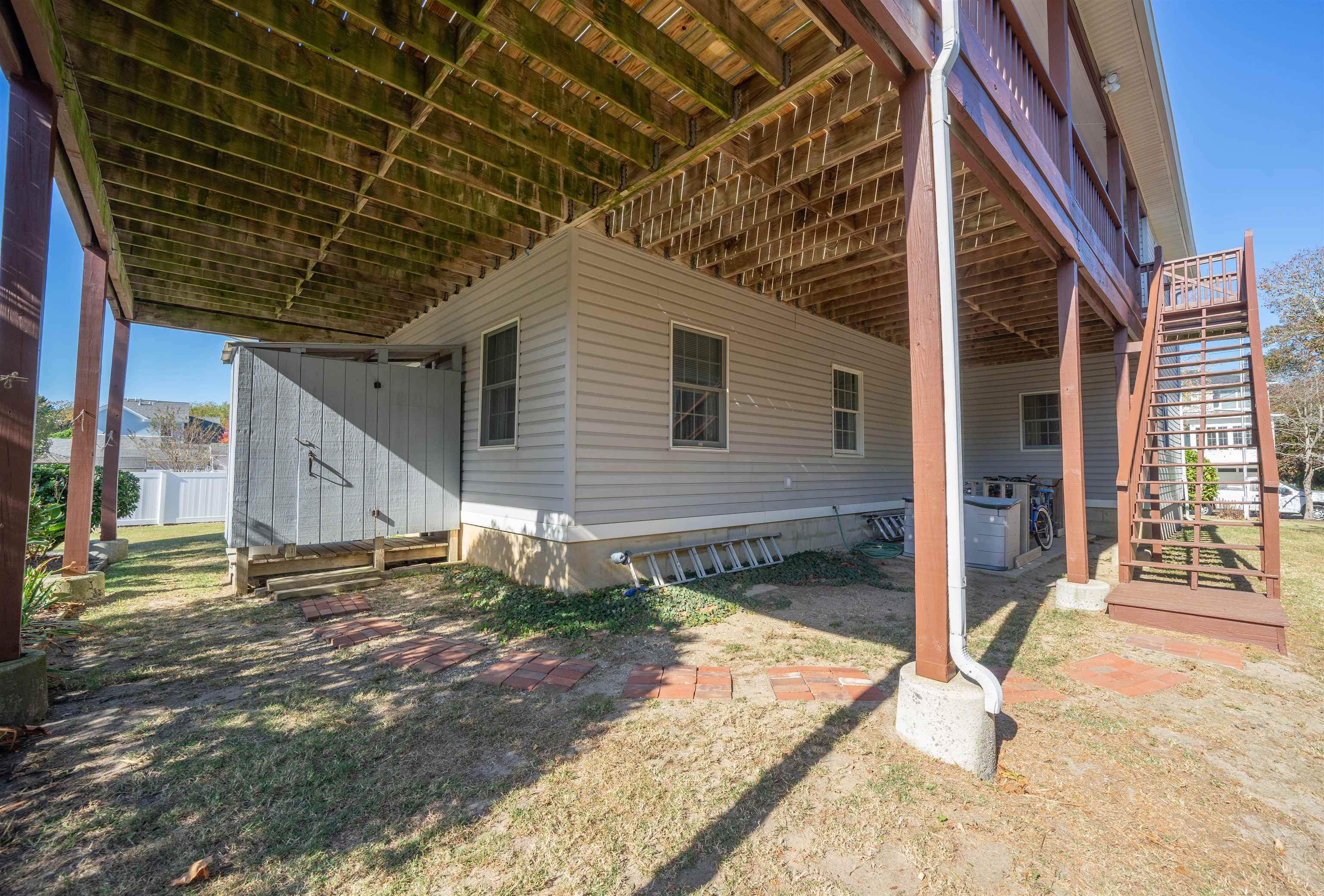 210 3rd West Cape Cape May, NJ 08204 - Photo 25 of 31 a backyard of a house with basket ball court and wooden fence