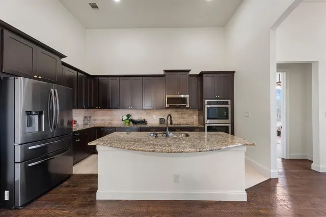 a view of a kitchen counter space cabinets and stainless steel appliances