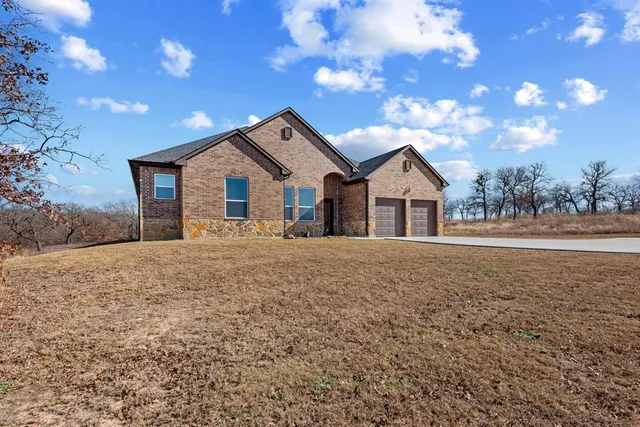 a view of house with yard and entertaining space