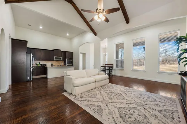 a living room with furniture and kitchen view