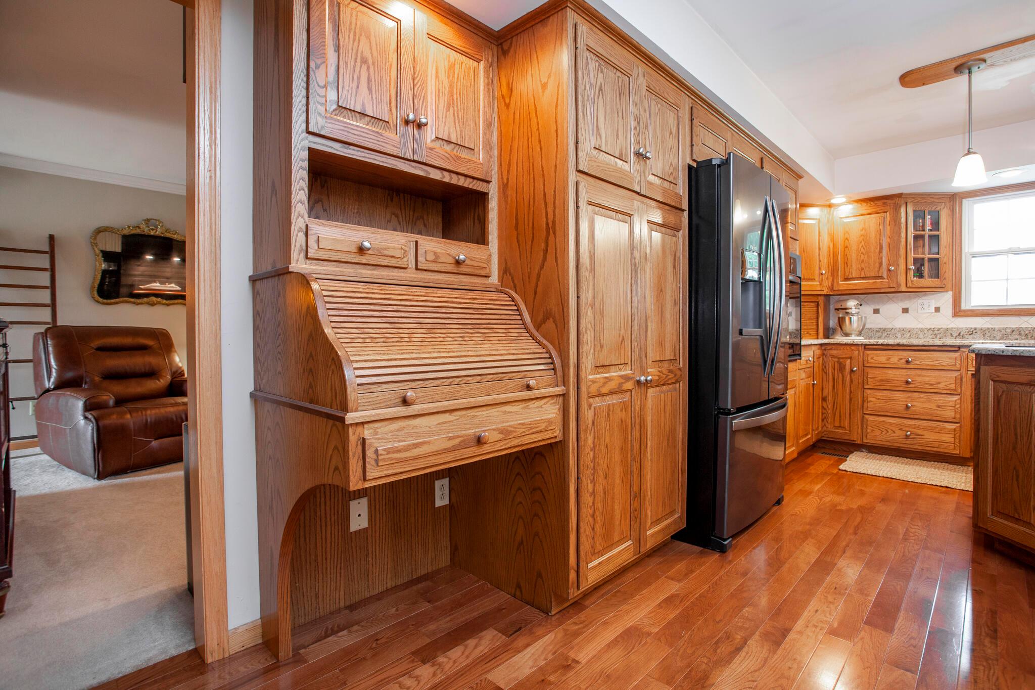 4979 Nickelson Road Prospect, OH 43342 - Photo 21 of 68 Kitchen with roll-top desk, fridge with cabinet surround