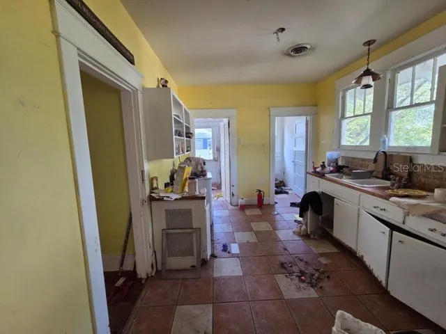 a kitchen with sink refrigerator and window