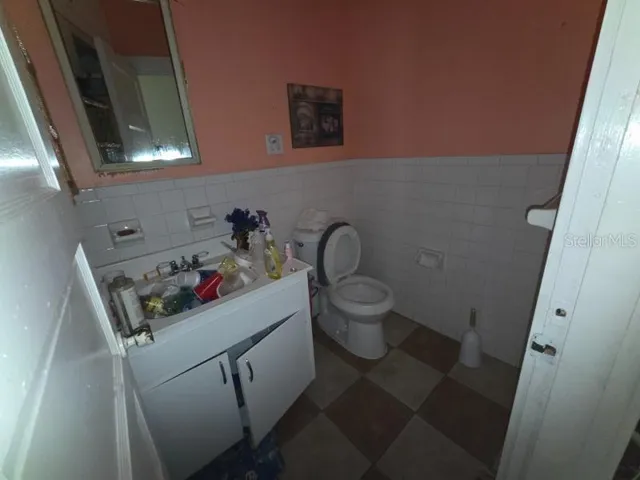 a bathroom with a toilet sink and mirror