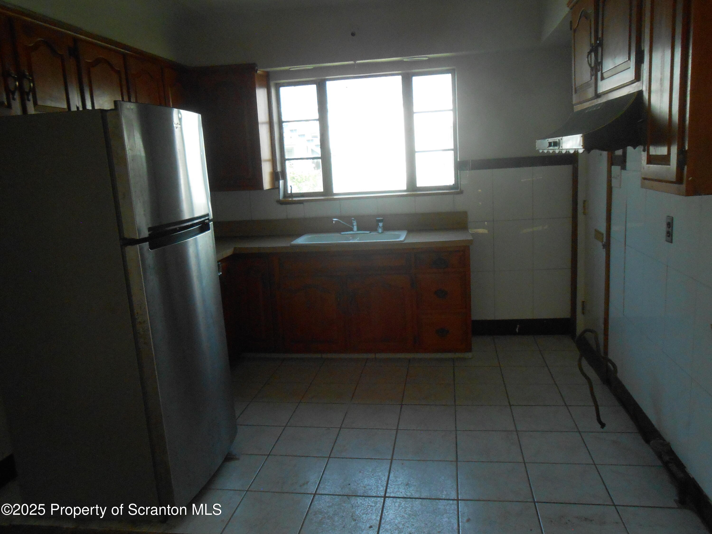 622 North Main Avenue, Unit 7 Scranton, PA 18504 - Photo 2 of 14 a view of a refrigerator in kitchen and window