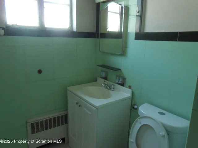 a bathroom with sink toilet and mirror
