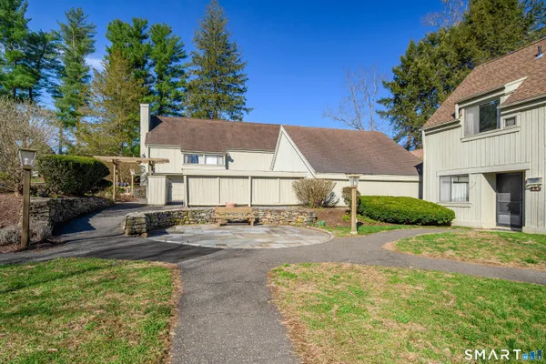 a view of a house with a yard and sitting area
