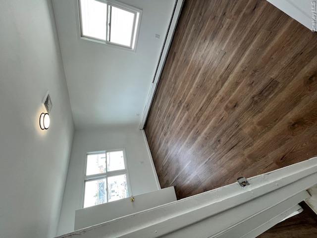 94 Roger Avenue Inwood, NY 11096 - Photo 14 of 28 an empty room with wooden floor and windows