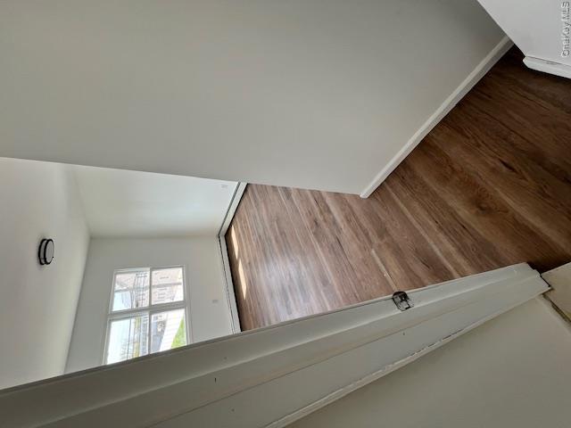 94 Roger Avenue Inwood, NY 11096 - Photo 18 of 28 wooden floor in an empty room with a window
