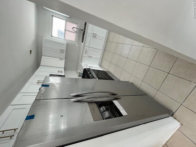 94 Roger Avenue Inwood, NY 11096 - Photo 20 of 28 a kitchen with stainless steel appliances cabinets and a refrigerator