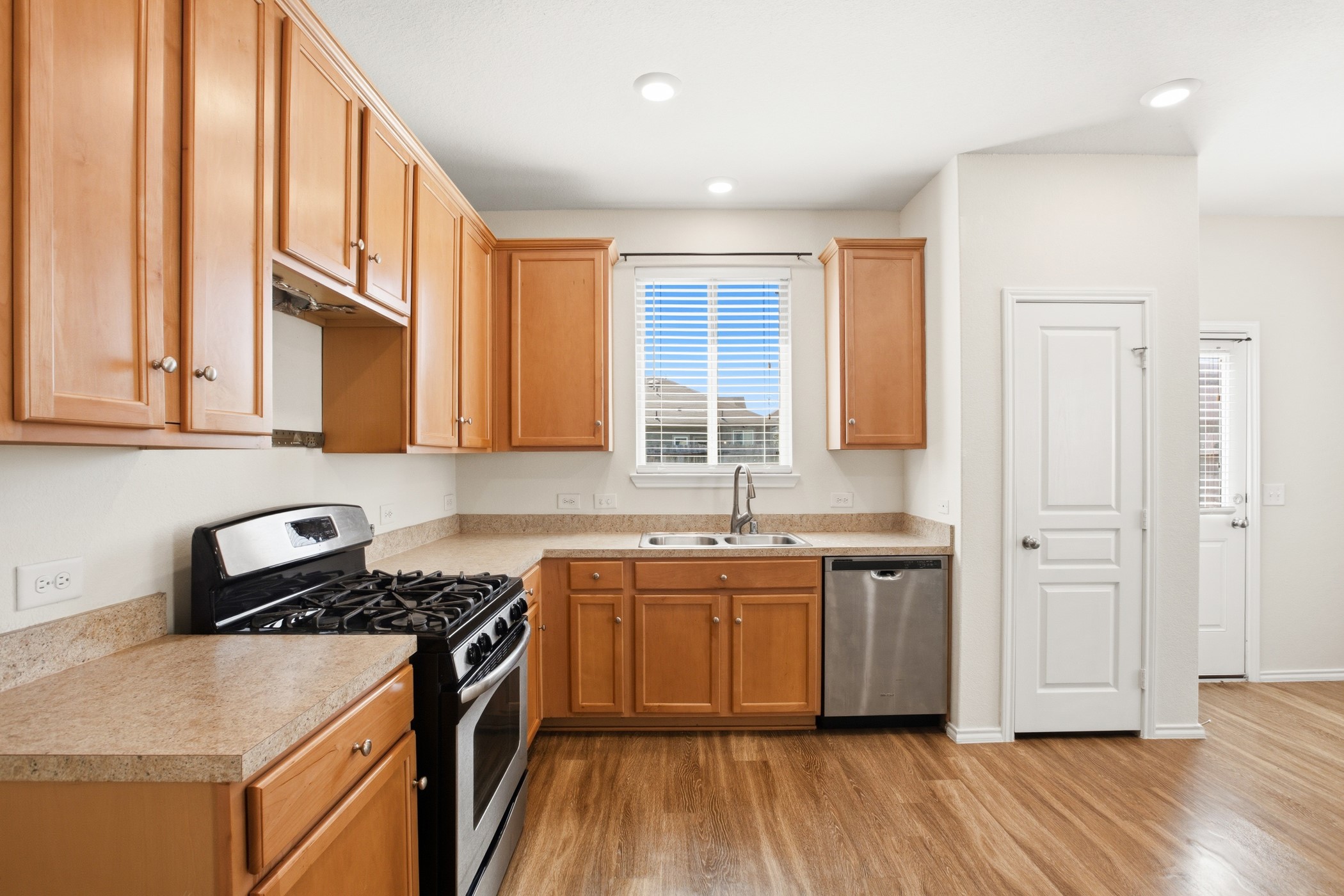 4611 Windmill Run Drive Houston, TX 77069 - Photo 14 of 35 a kitchen with stainless steel appliances granite countertop a stove a sink and a refrigerator with wooden floors
