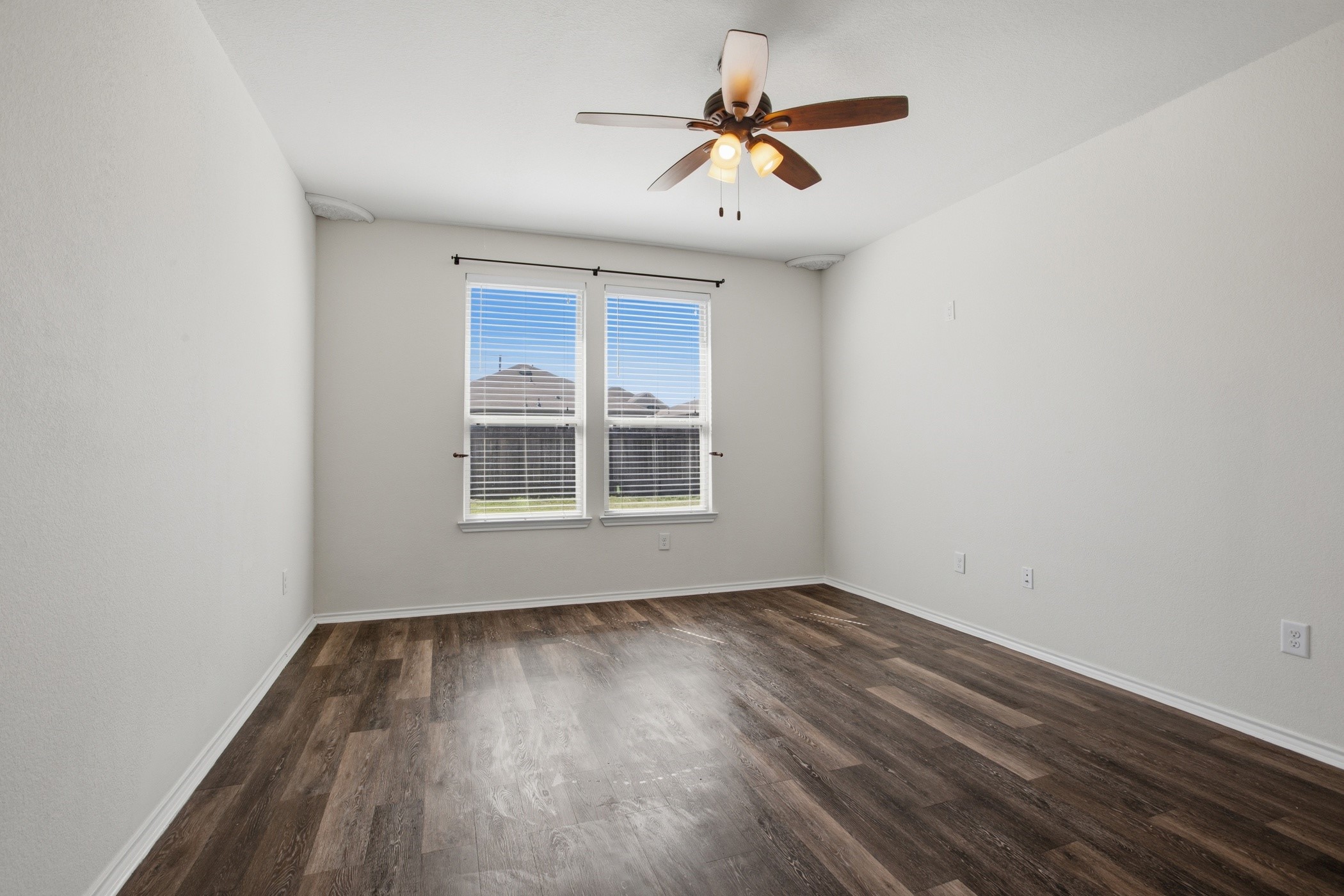 4611 Windmill Run Drive Houston, TX 77069 - Photo 19 of 35 an empty room with wooden floor and windows