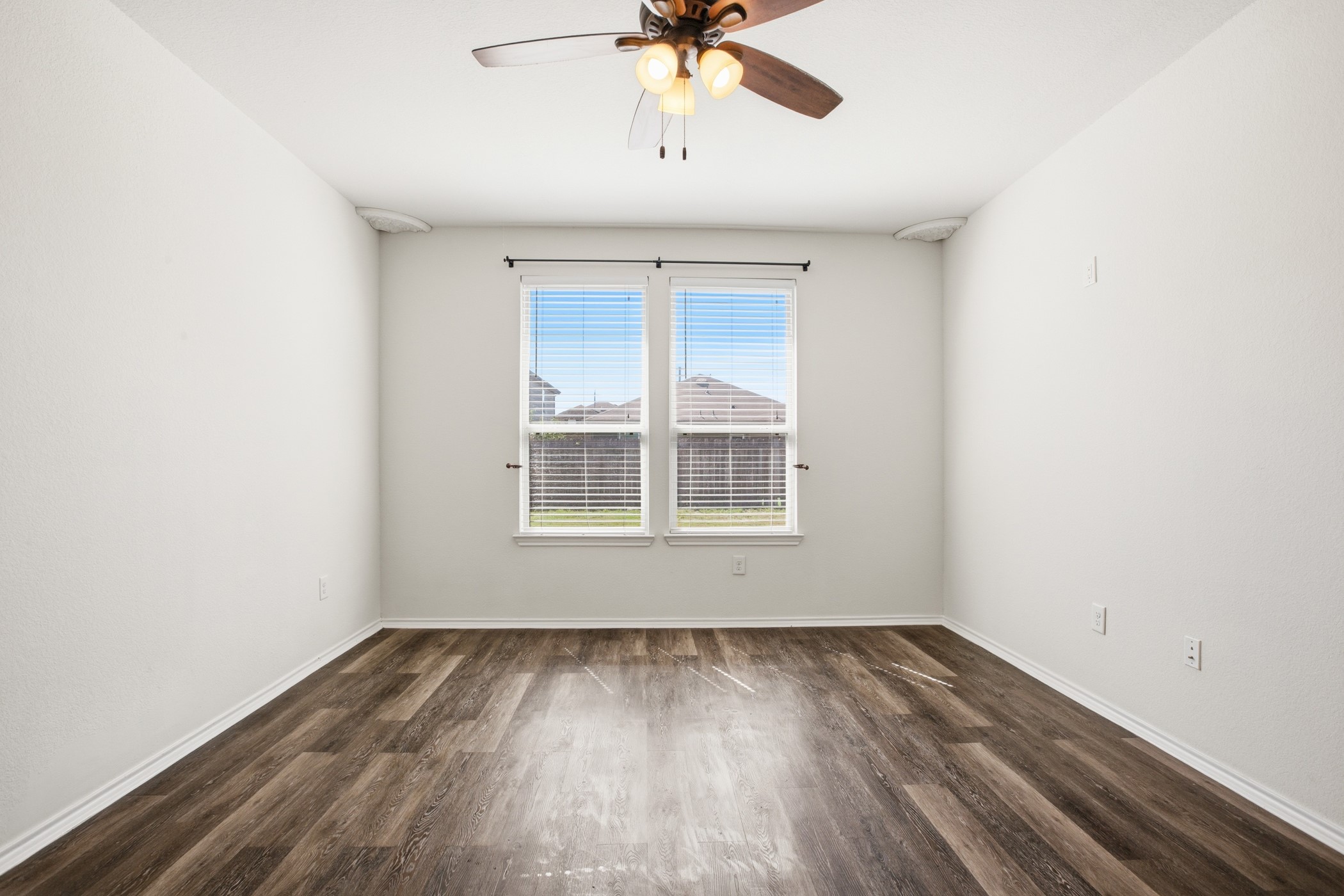 4611 Windmill Run Drive Houston, TX 77069 - Photo 20 of 35 an empty room with a window and a ceiling fan